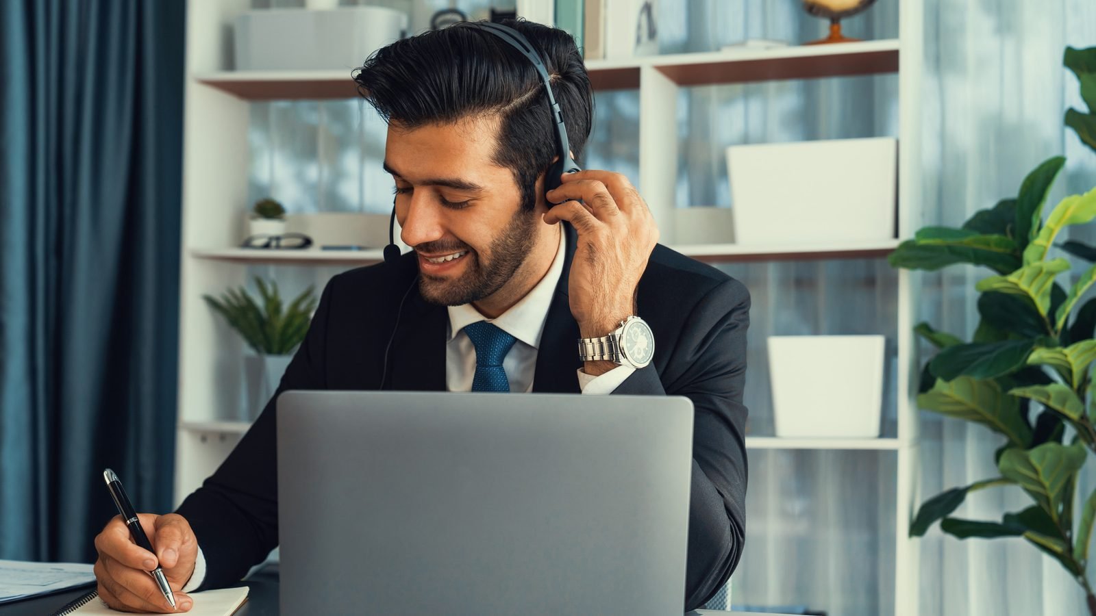 A salesperson on a call with a laptop open